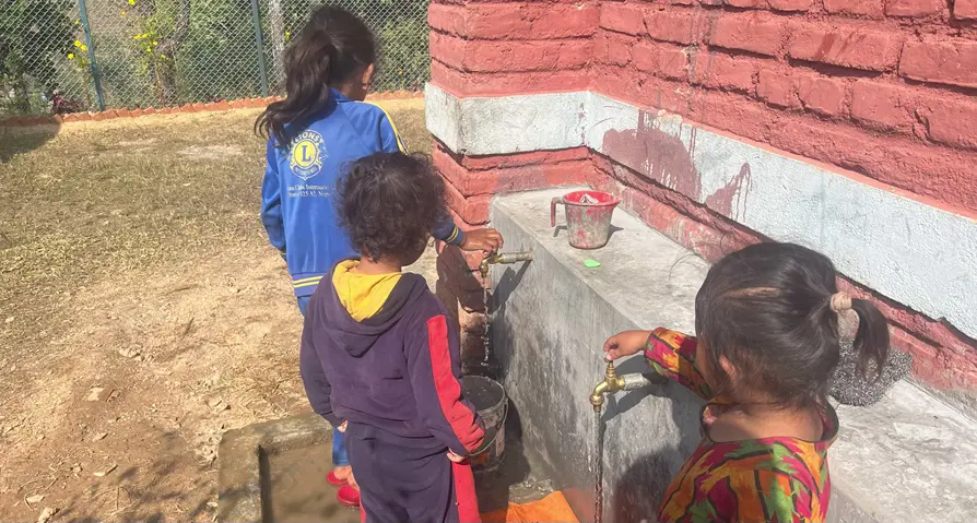 Students enjoy fresh running water from the newly installed tap